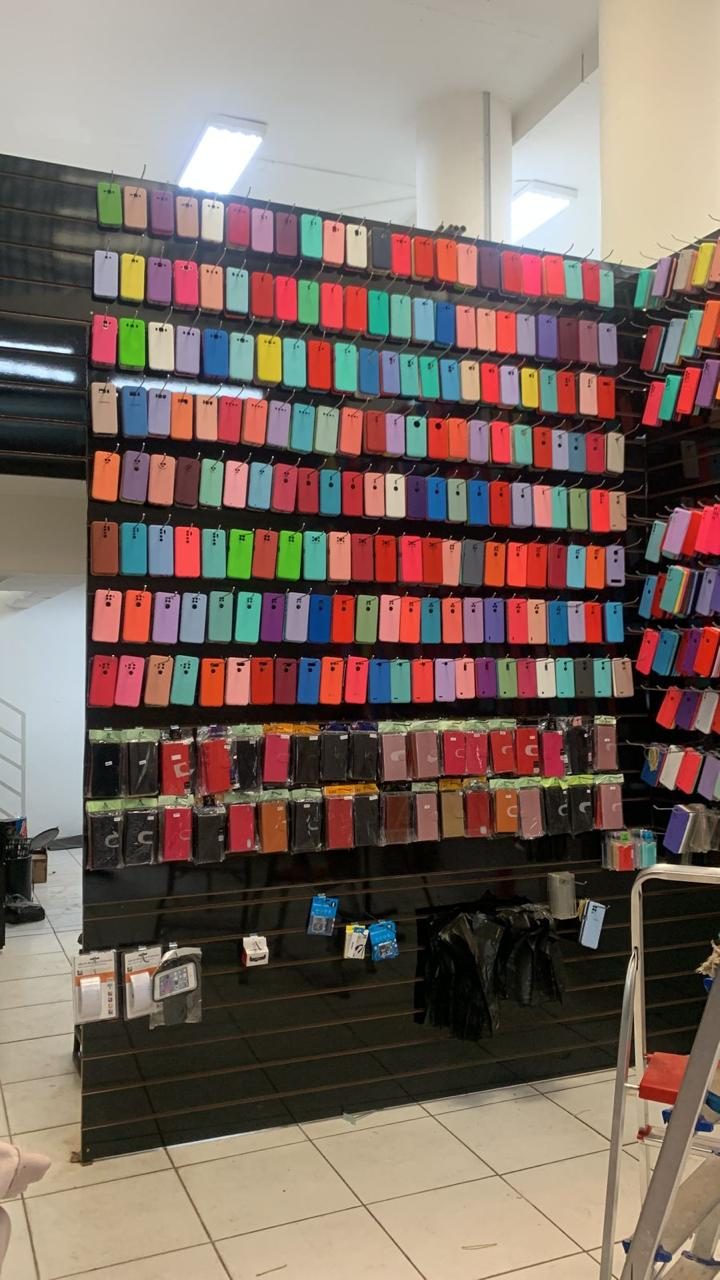 Parede repleta de capinhas coloridas na loja Mercado das Capas
